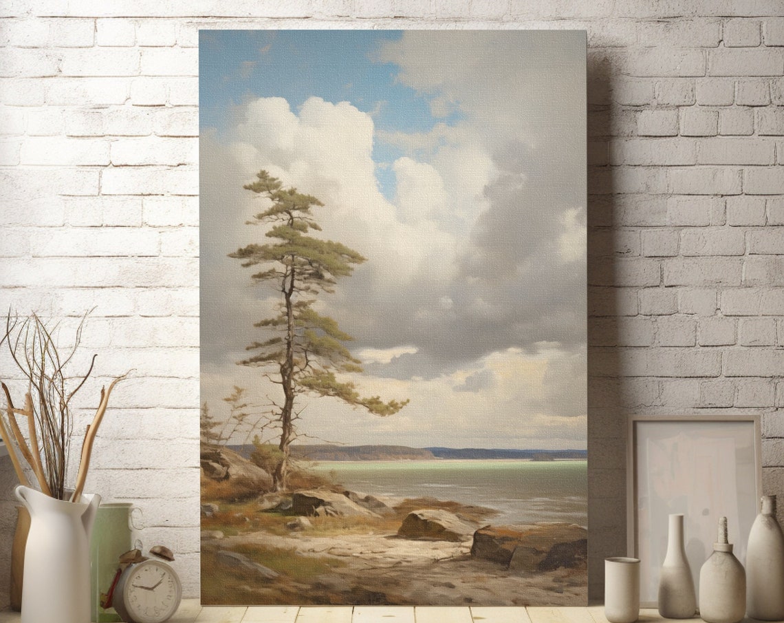 Lone Pine Tree on Rocky Shore Beneath Dramatic Cloudy Sky Poster