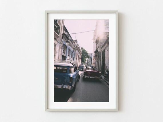 Vintage American Cars Driving Down Sunlit Old Town Street Photo Poster