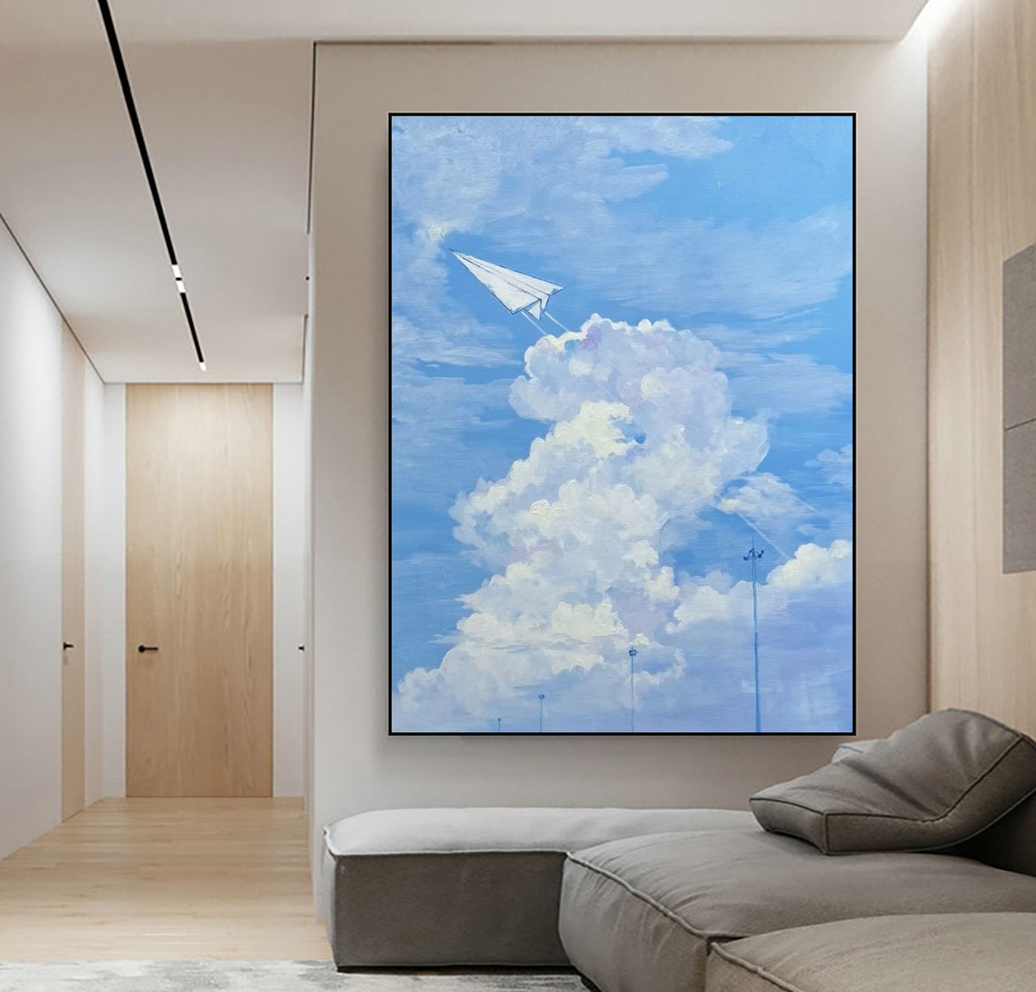 Paper Airplane Soaring Through Blue Sky with White Clouds Art Poster - Image 3