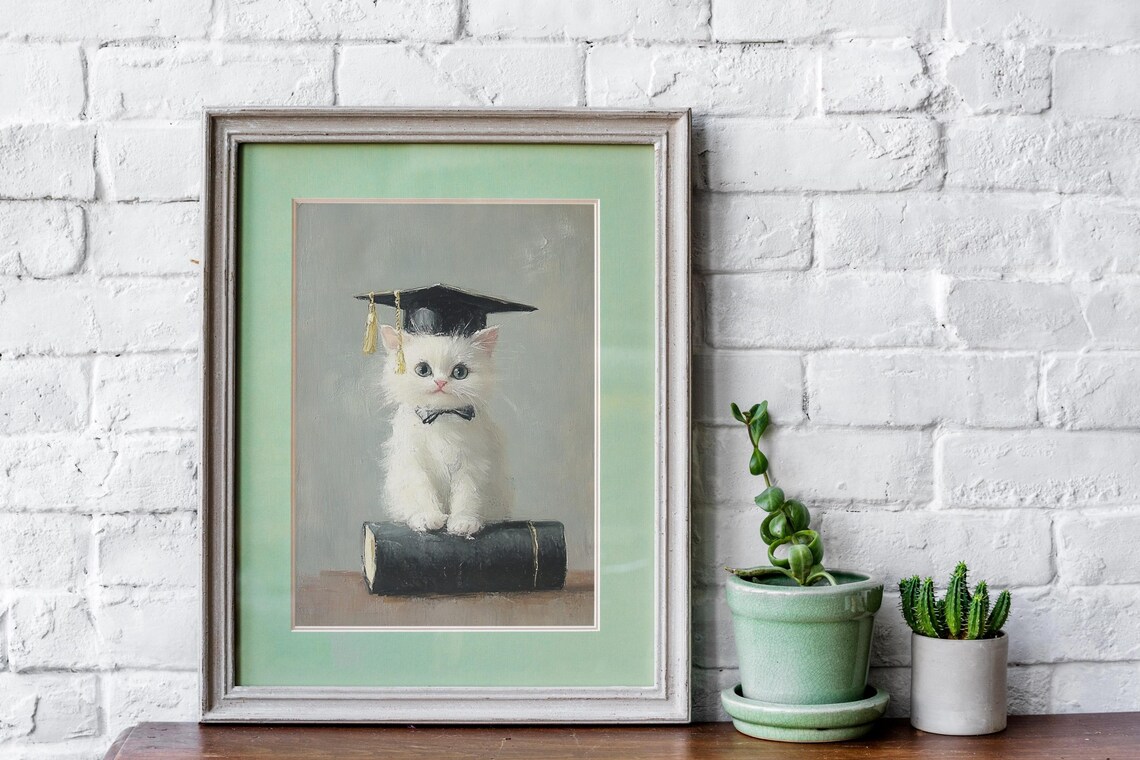 White Kitten in Graduation Cap with Bow Tie Sitting on Book Poster - Image 4