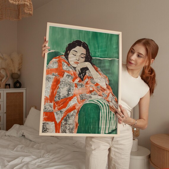 Woman In Orange Plaid Blanket Resting Against Emerald Green Poster