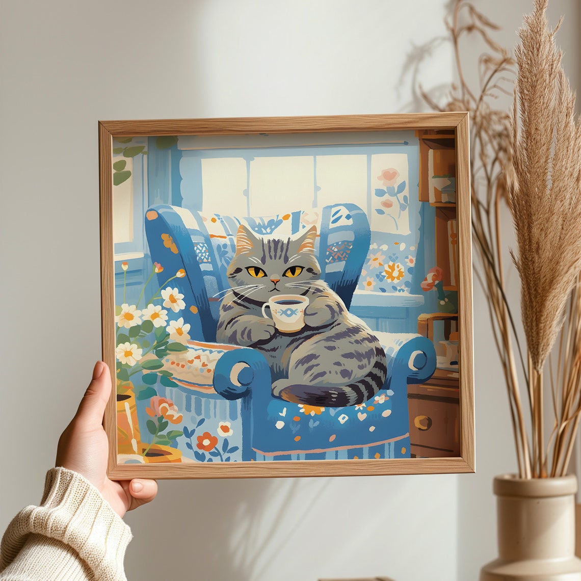 Content Silver Tabby Cat Holding Fish Mug in Blue Armchair Poster - Image 3