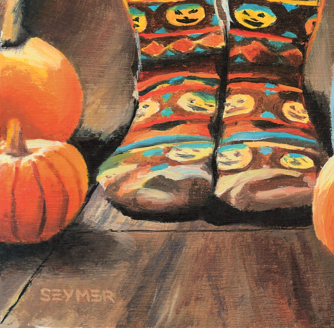 Cozy Halloween Scene with Pumpkin Socks, Pumpkins and Candlelight Poster - Image 3