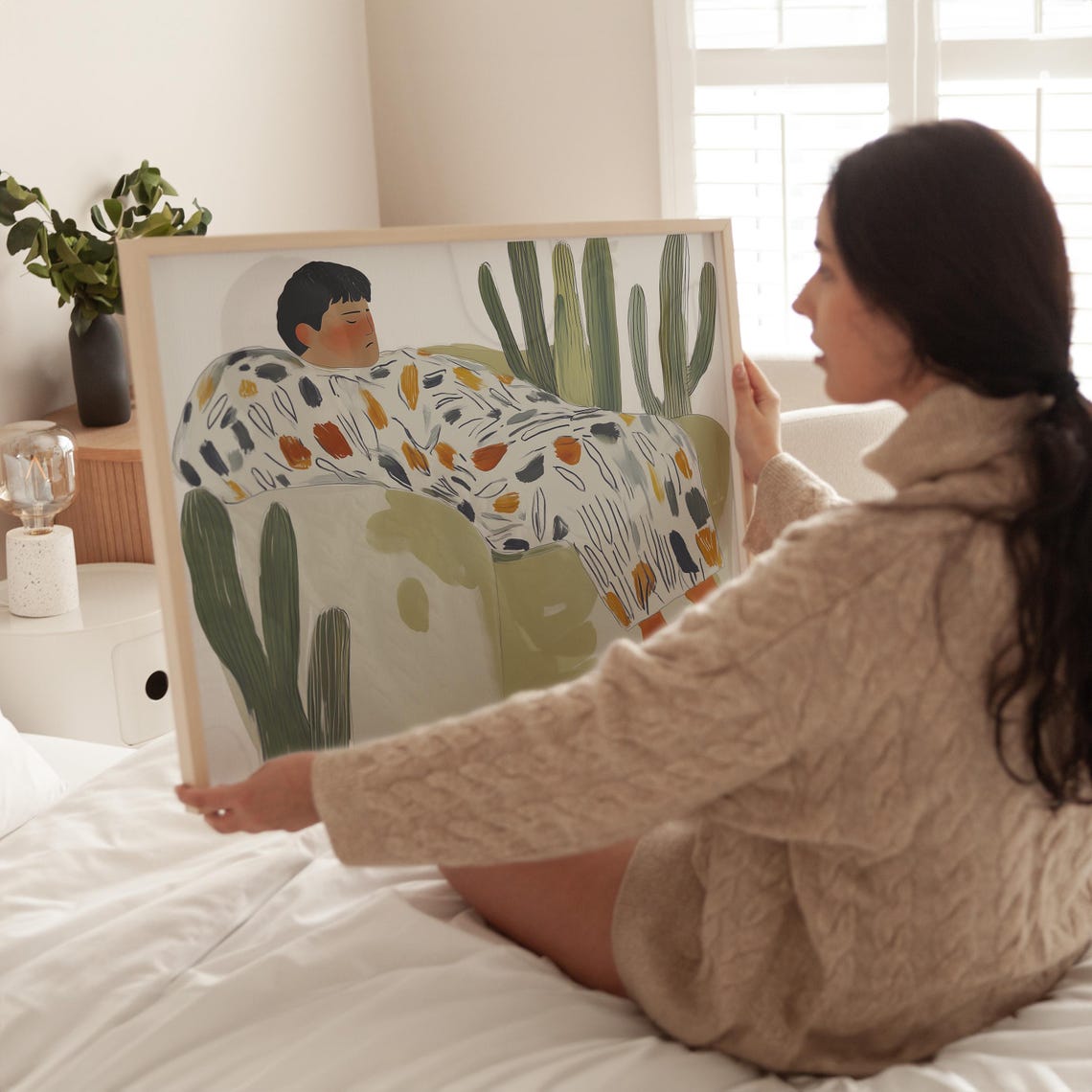 Person Resting on Green Couch Surrounded by Tall Cacti Poster - Image 3
