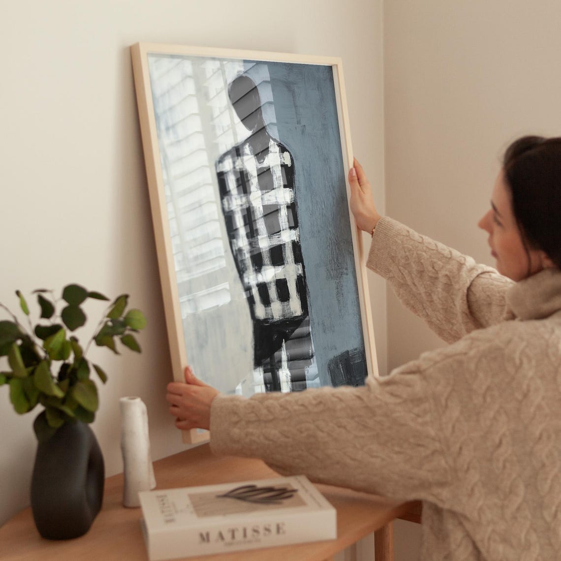 Faceless Figure In Checkered Shirt On Minimalist Grey Wall Art - Image 2