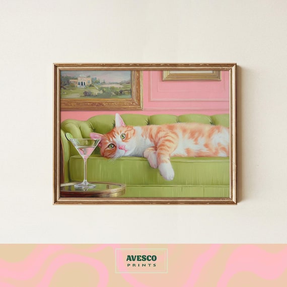 Orange Tabby Cat Resting On A Green Sofa Beside A Martini Poster