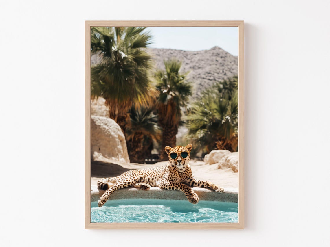Cheetah Wearing Sunglasses Lounging at a Desert Oasis Pool Poster