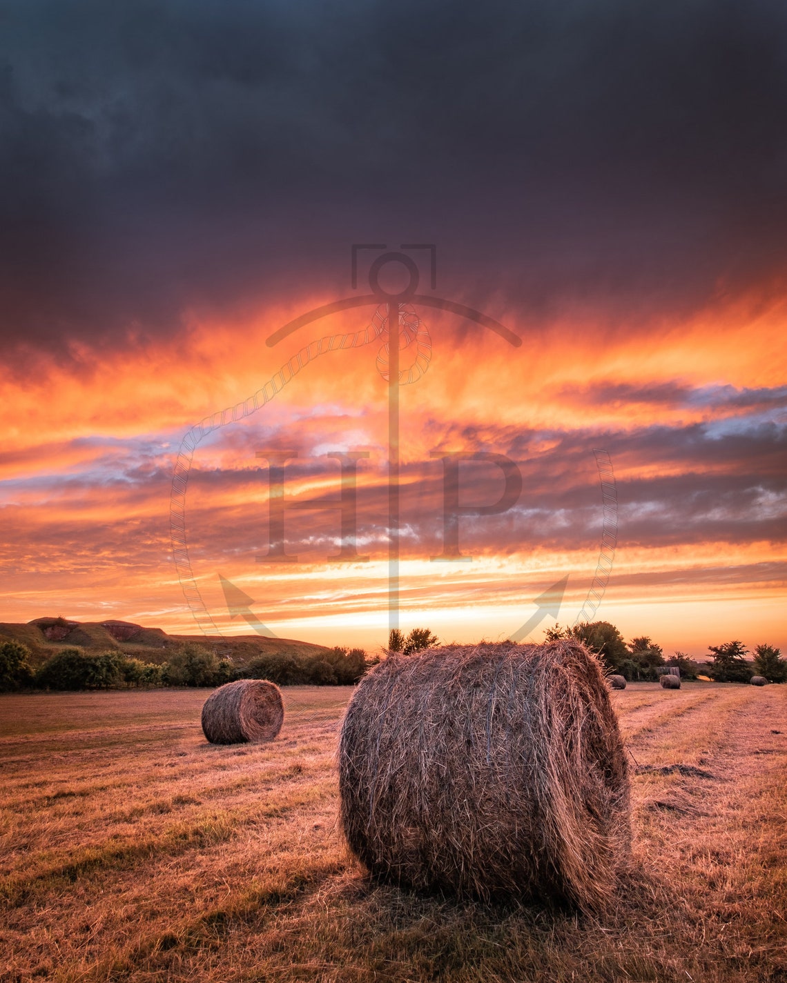 Round Hay Bales In Golden Field Under Fiery Sunset Sky Poster - Image 3