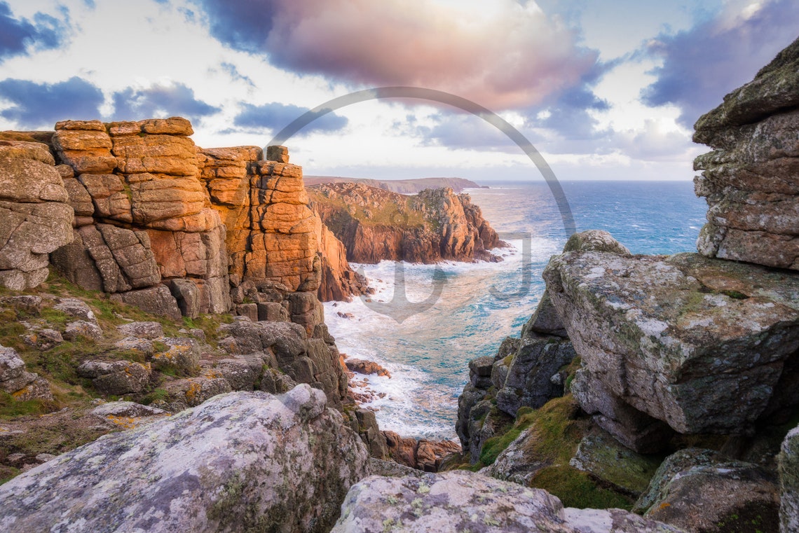 Towering Granite Sea Cliffs Bathed in Warm Golden Light Poster - Image 3