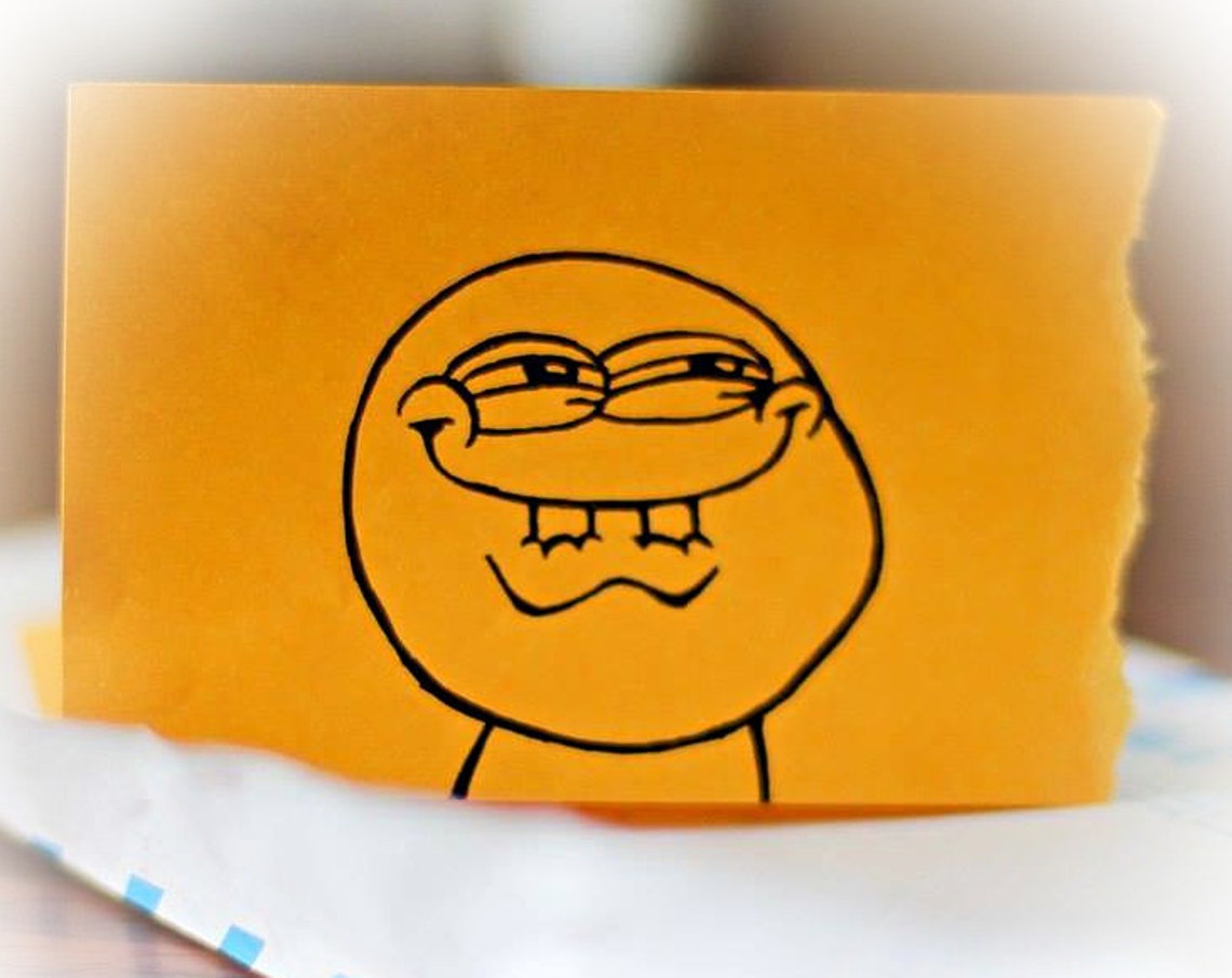 Funny Grinning Meme Doodle Face On Orange Sketch Paper Poster