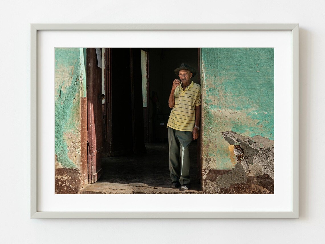 Old Man In Sunlit Doorway Of Weathered Turquoise House Photo Poster