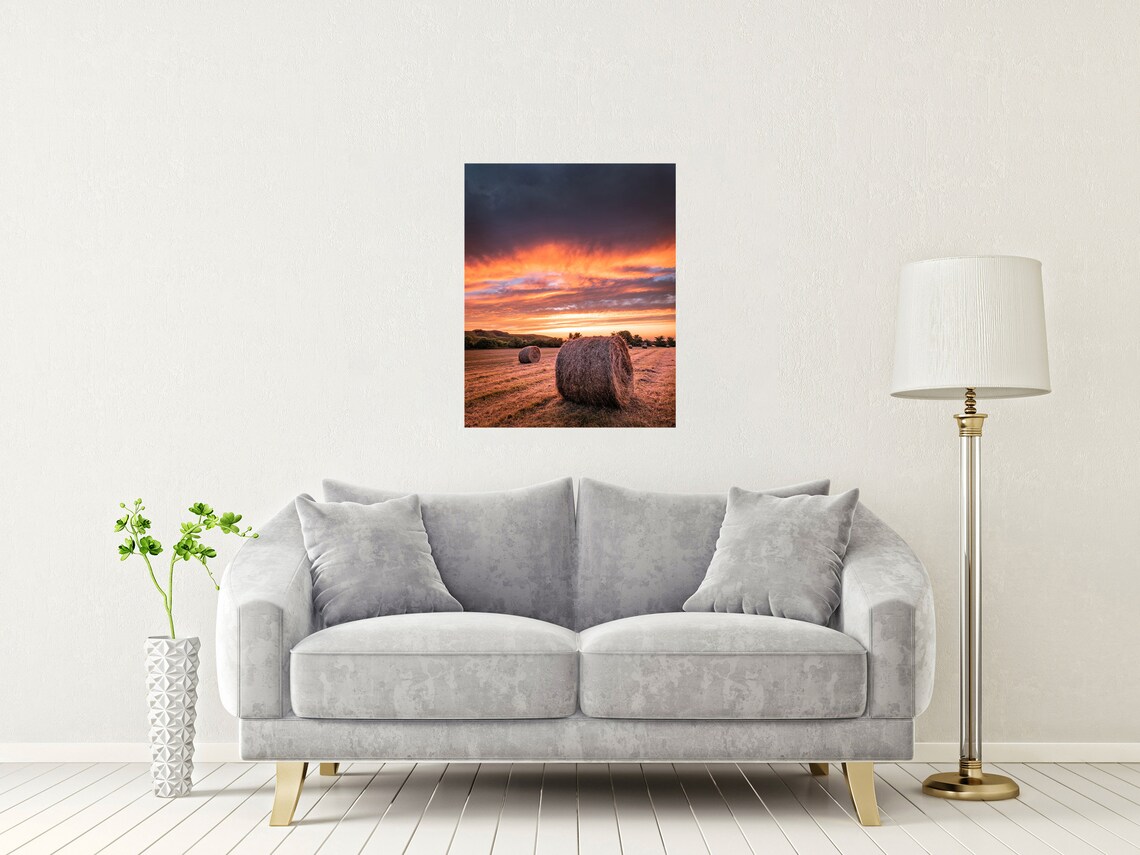 Round Hay Bales In Golden Field Under Fiery Sunset Sky Poster - Image 2