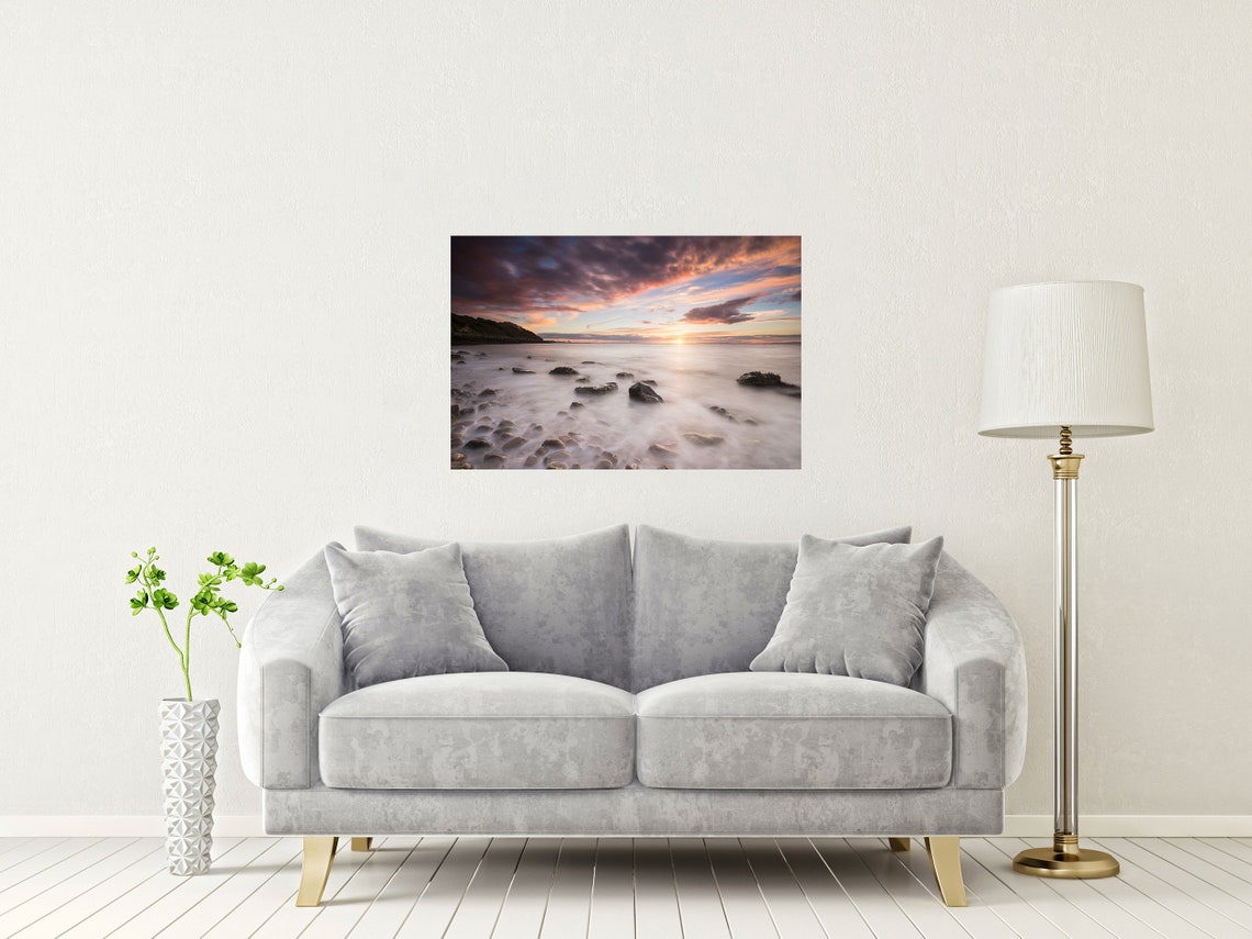 Dramatic Sunset Over Rocky Shoreline with Long Exposure Poster - Image 2