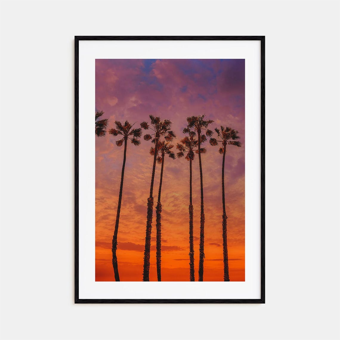 Huntington Beach Palm Silhouettes Against a Fiery Sunset Sky Poster