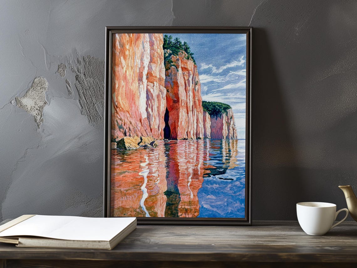 Orange Sea Cliffs with Dark Cave Reflection in Calm Water Poster