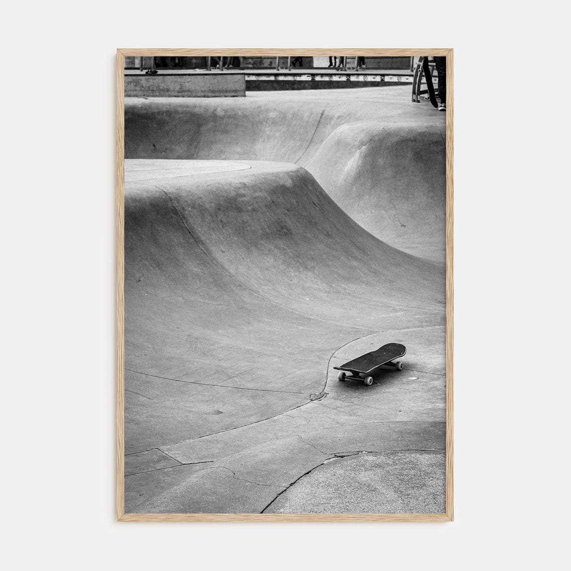 Black and White Skateboard Resting in an Empty Concrete Bowl Poster