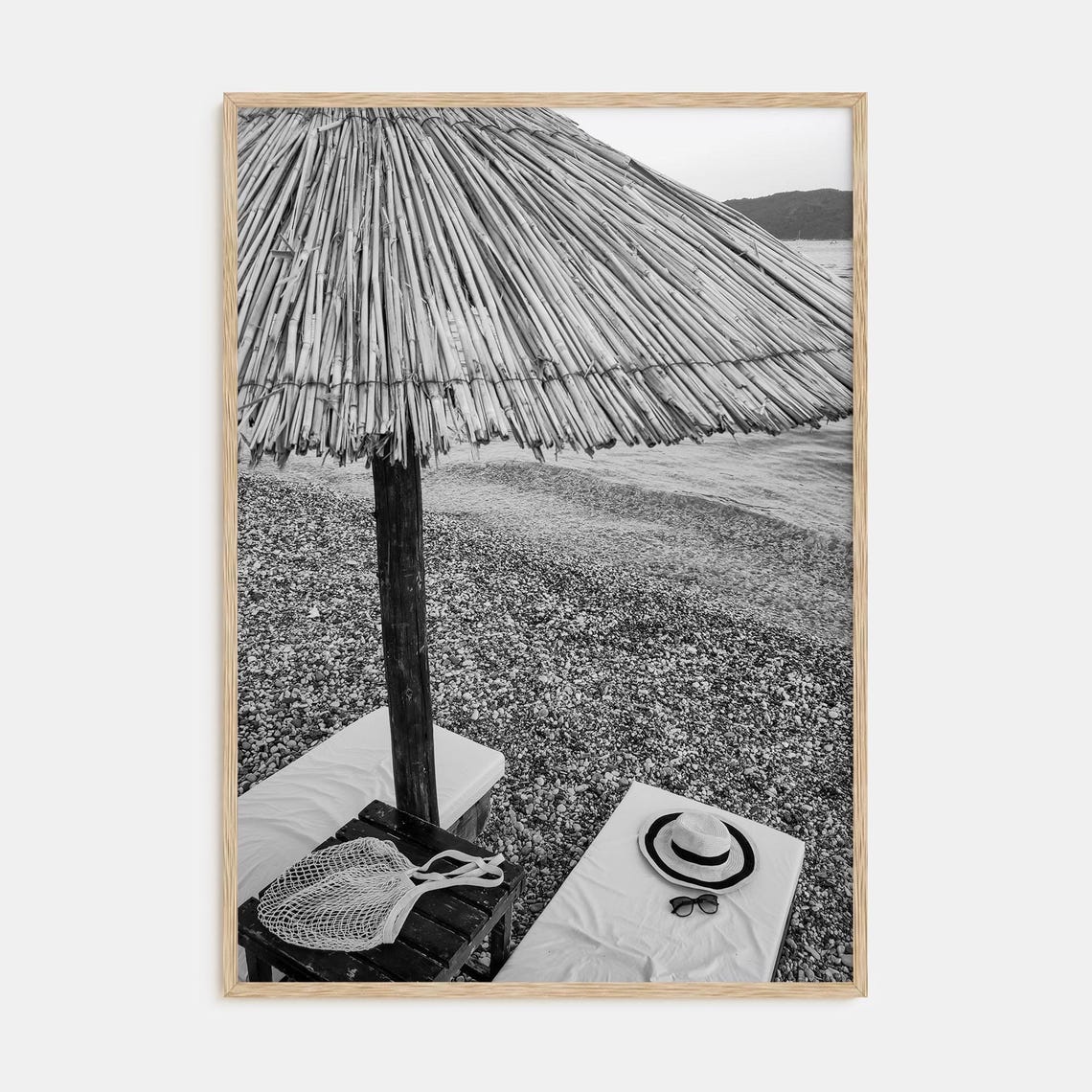 Straw Beach Umbrella on Pebble Shore Black and White Art Poster