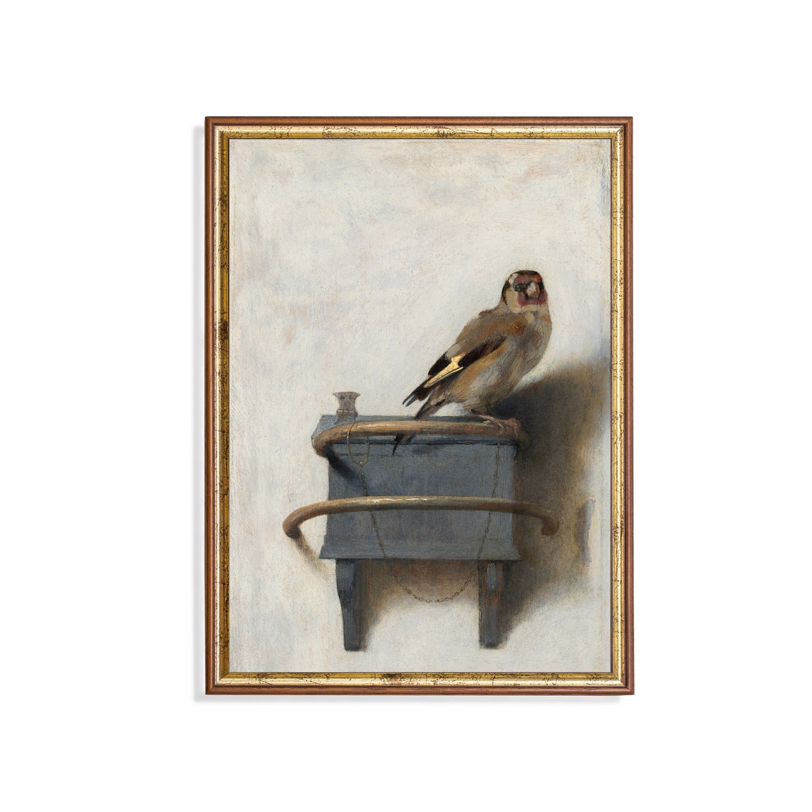 Chained Goldfinch Perched Atop a Small Wall-Mounted Feeder Poster