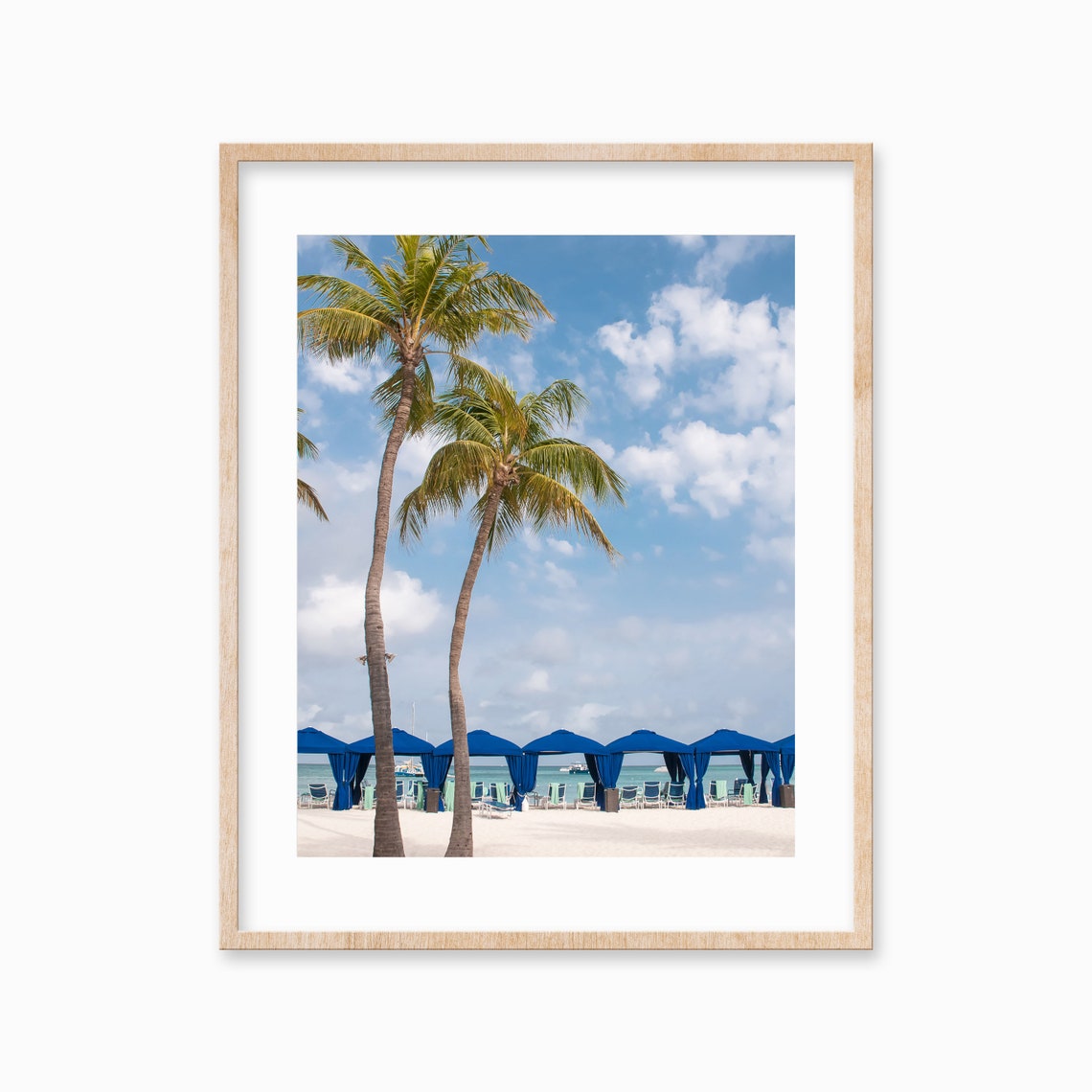 Leaning Palm Trees and Blue Beach Cabanas by the Ocean Poster