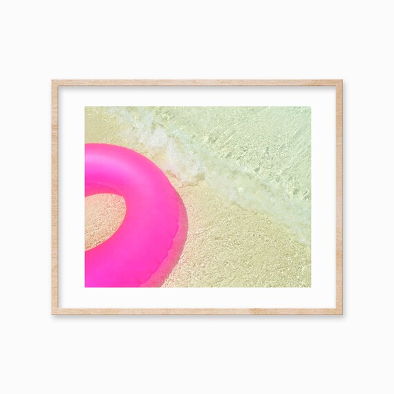 Hot Pink Pool Float Ring on the Edge of the Beach Shore Poster
