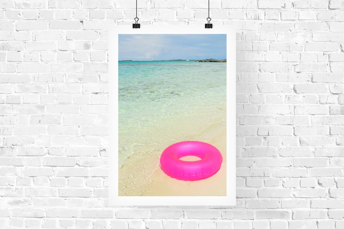 Pink Swim Ring Floating on Shallow Turquoise Beach Water Poster - Image 2