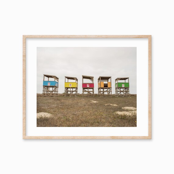 Row of Five Colorful Lifeguard Stands on Sandy Beach Photo Poster