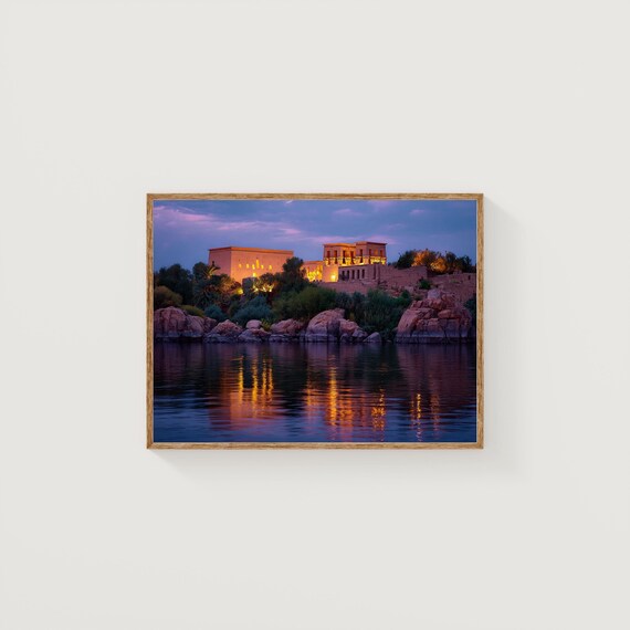 Ancient Egyptian Temple Illuminated at Night Across the Water Poster