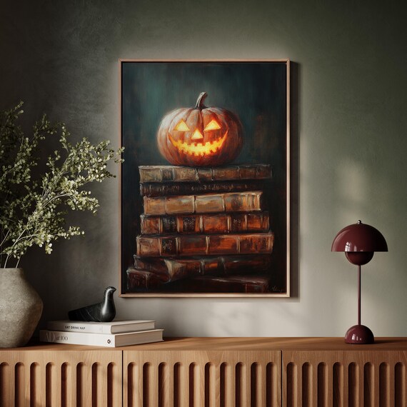 Carved Halloween Pumpkin Glowing on Old Vintage Books Poster
