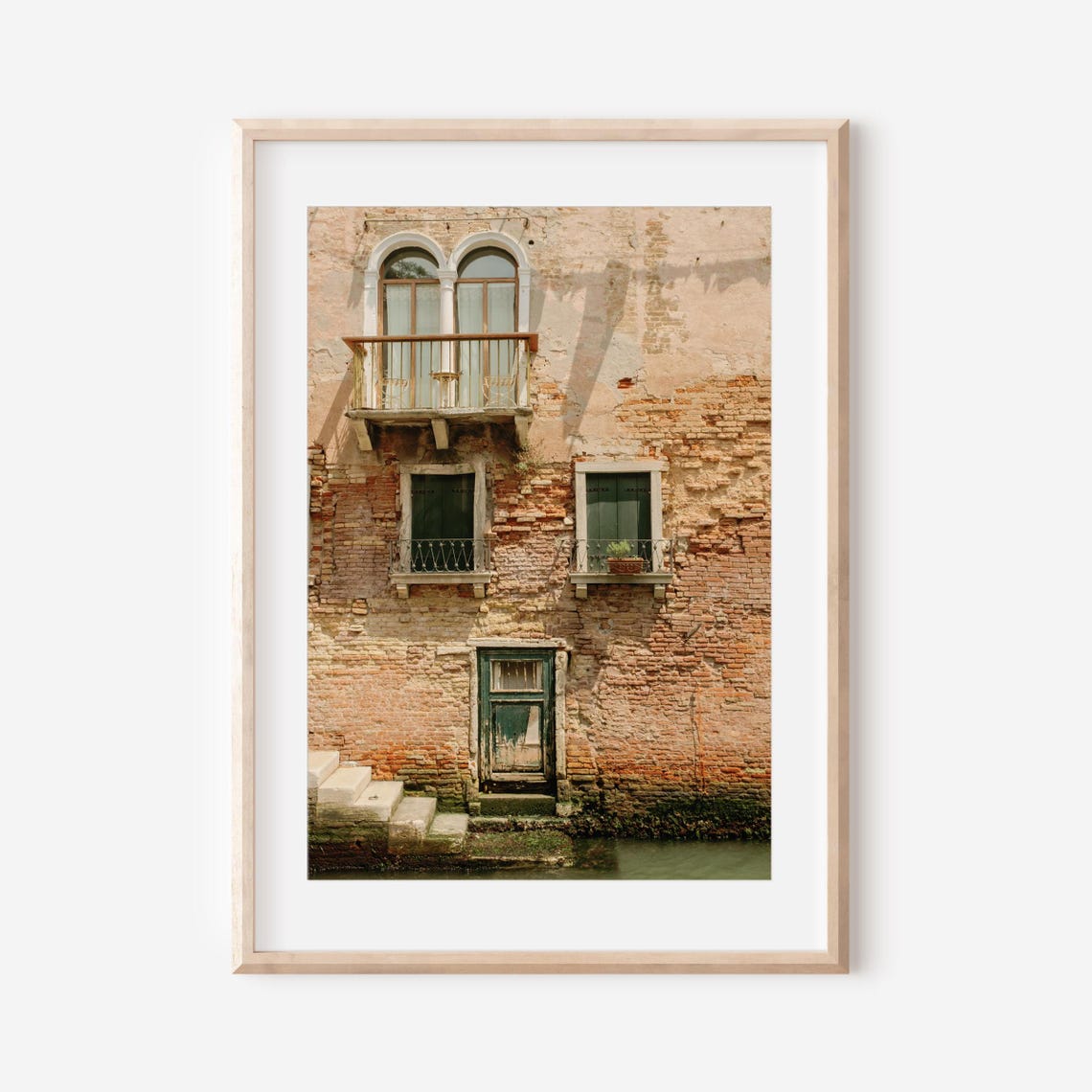 Venetian Brick Facade with Arched Balcony Over a Canal Poster