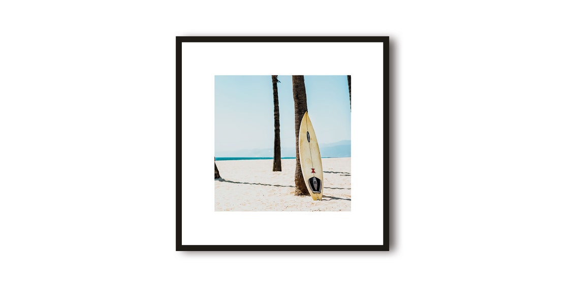 Surfboard Leaning Against a Palm Tree on a Sunny Beach Poster