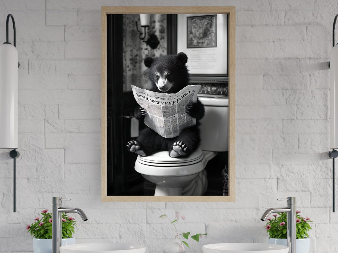 Funny Black Bear Cub Reading a Newspaper on the Toilet Poster