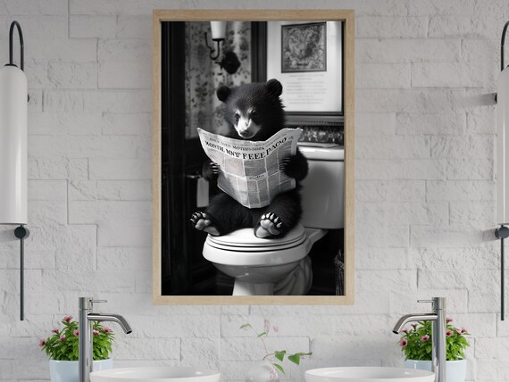 Funny Black Bear Cub Reading a Newspaper on the Toilet Poster