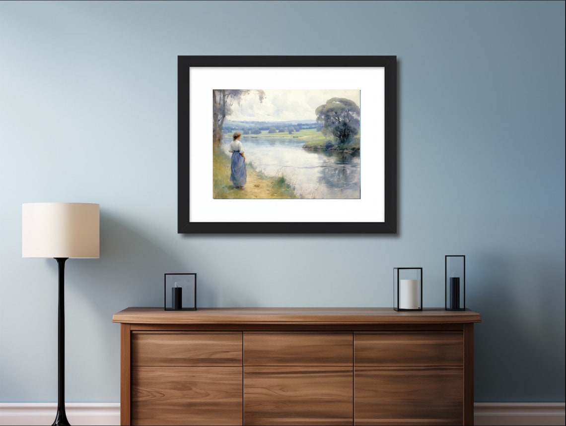 Woman Standing by a Wide River in Green Countryside Art Poster - Image 2