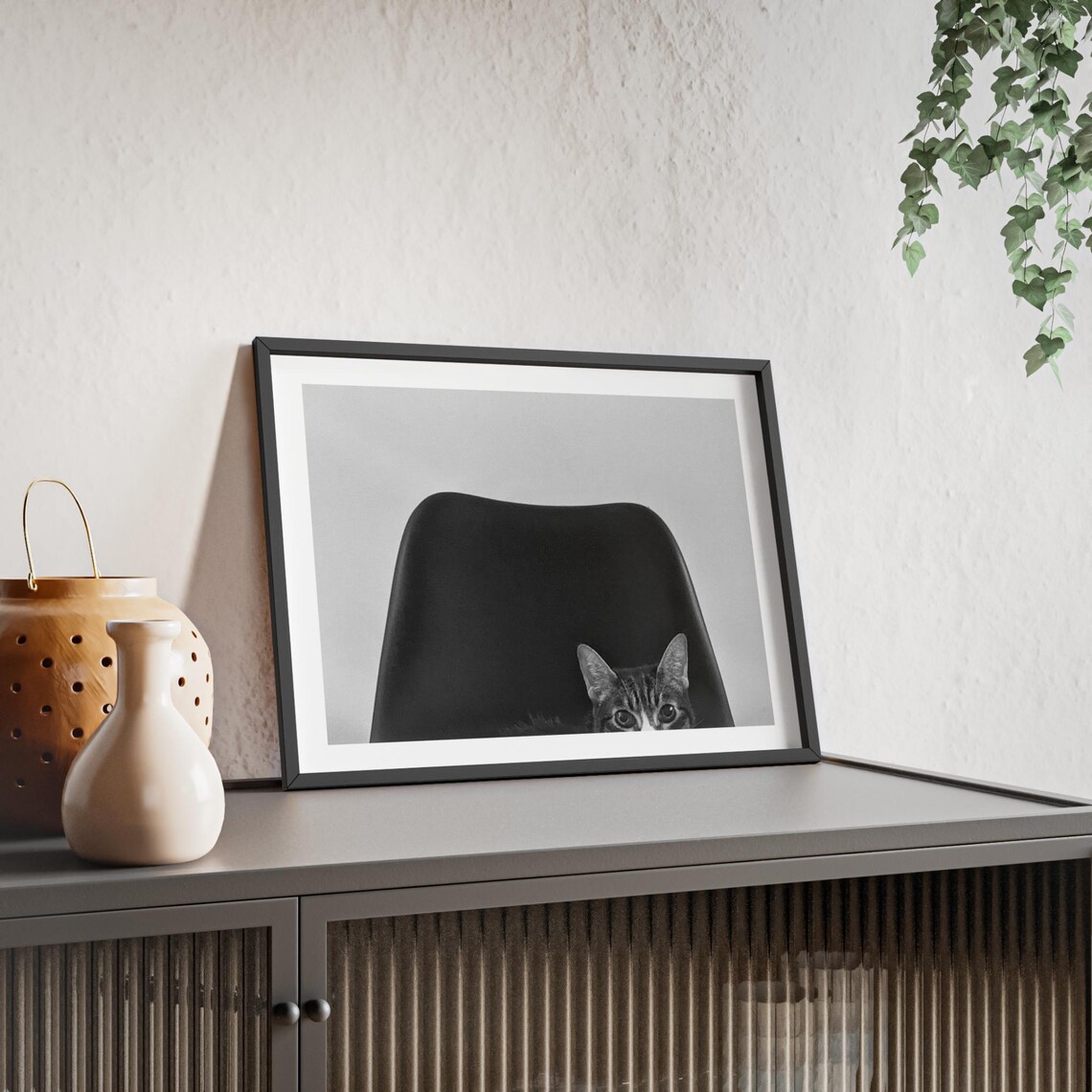 Tabby Cat Peeking Behind Black Chair Photography Wall Poster - Image 4