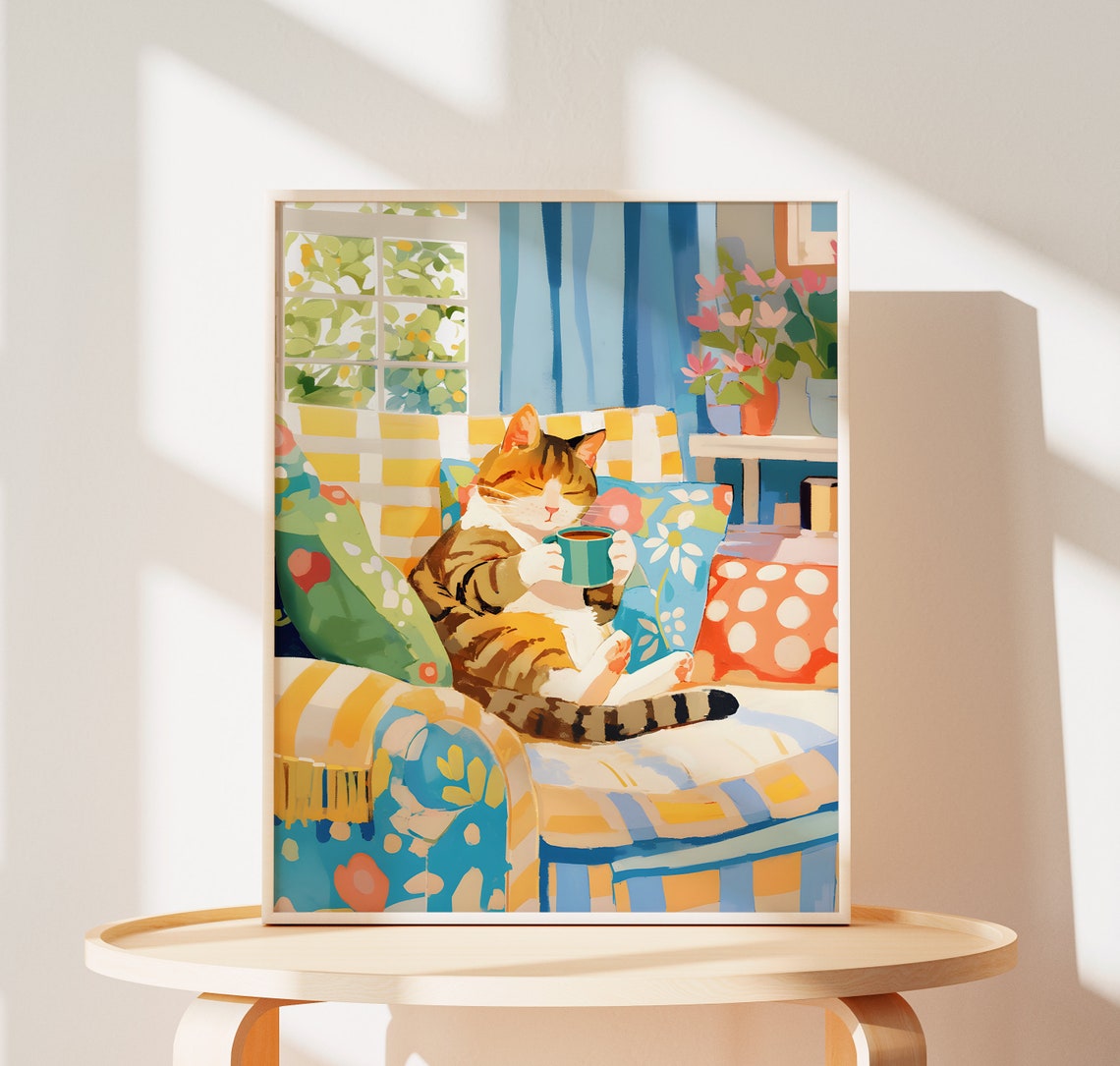 Sleepy Brown Tabby Cat with Green Mug on a Striped Chair Poster