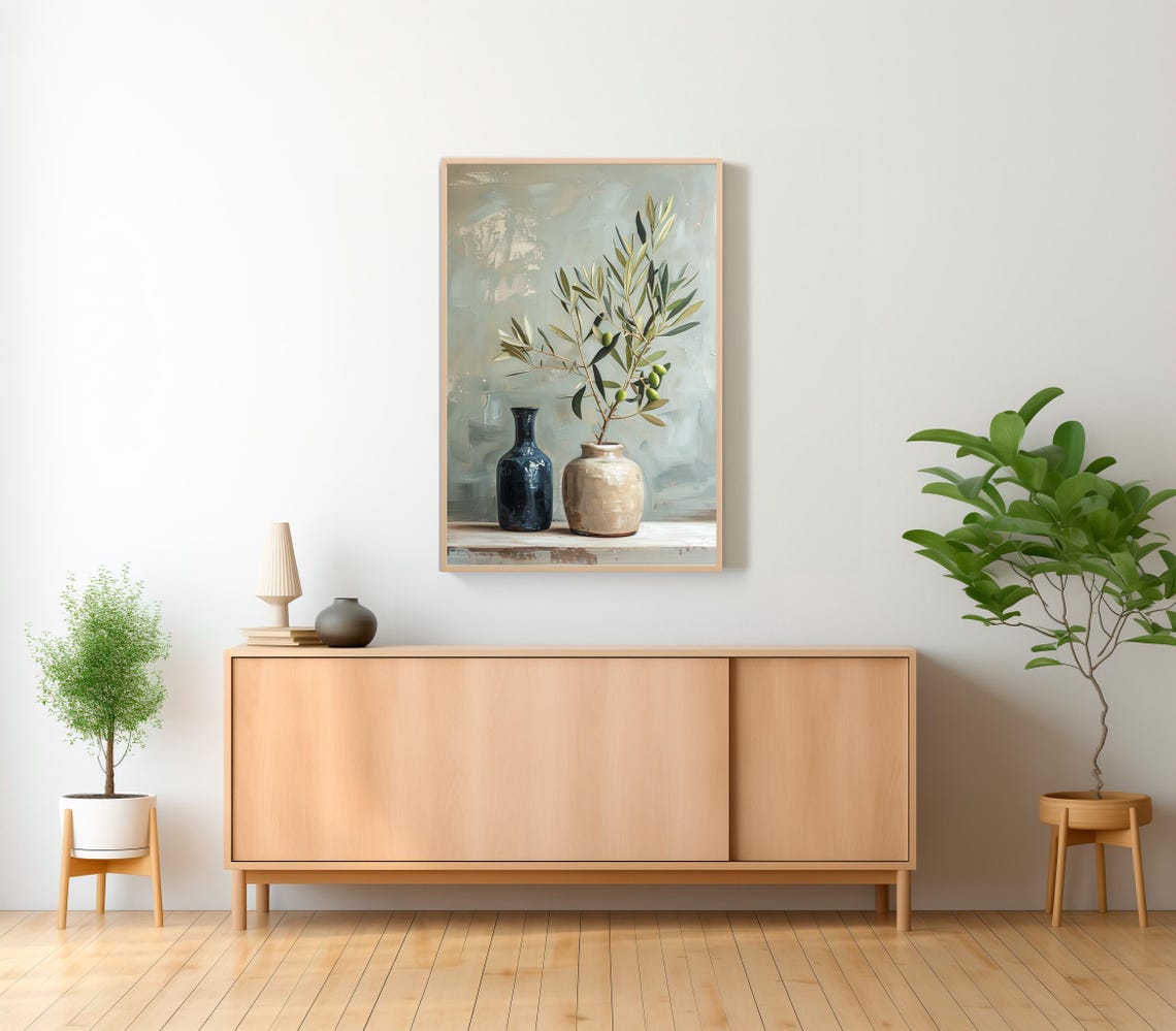 Single Olive Branch in a Ceramic Vase Beside a Blue Bottle Poster - Image 2