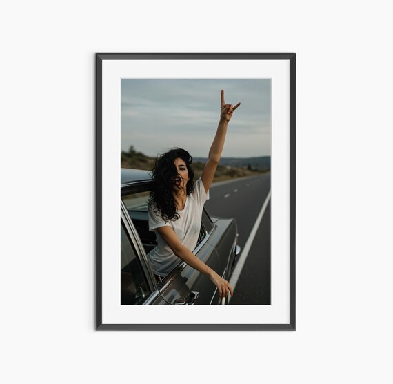 Woman Flashing Rock Hand Sign From Classic Car Window Sunset Photo Print