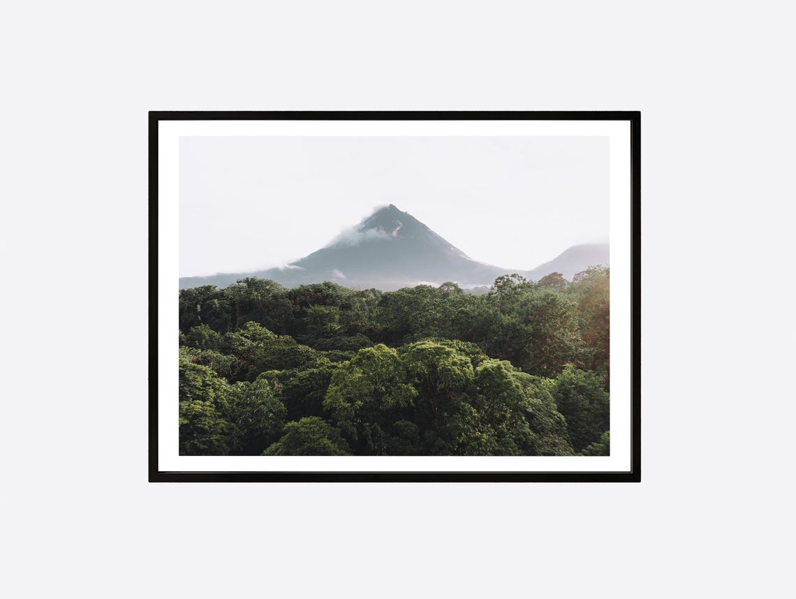 Misty Rainforest Canopy With a Volcano Rising Above the Jungle Poster