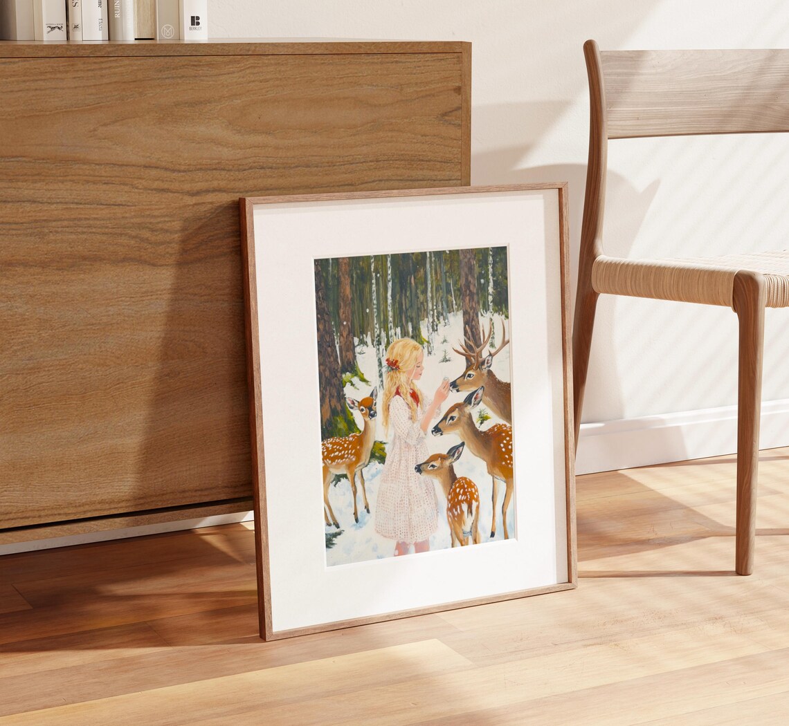 Young Girl in White Dress Feeding Deer in Snowy Forest Poster