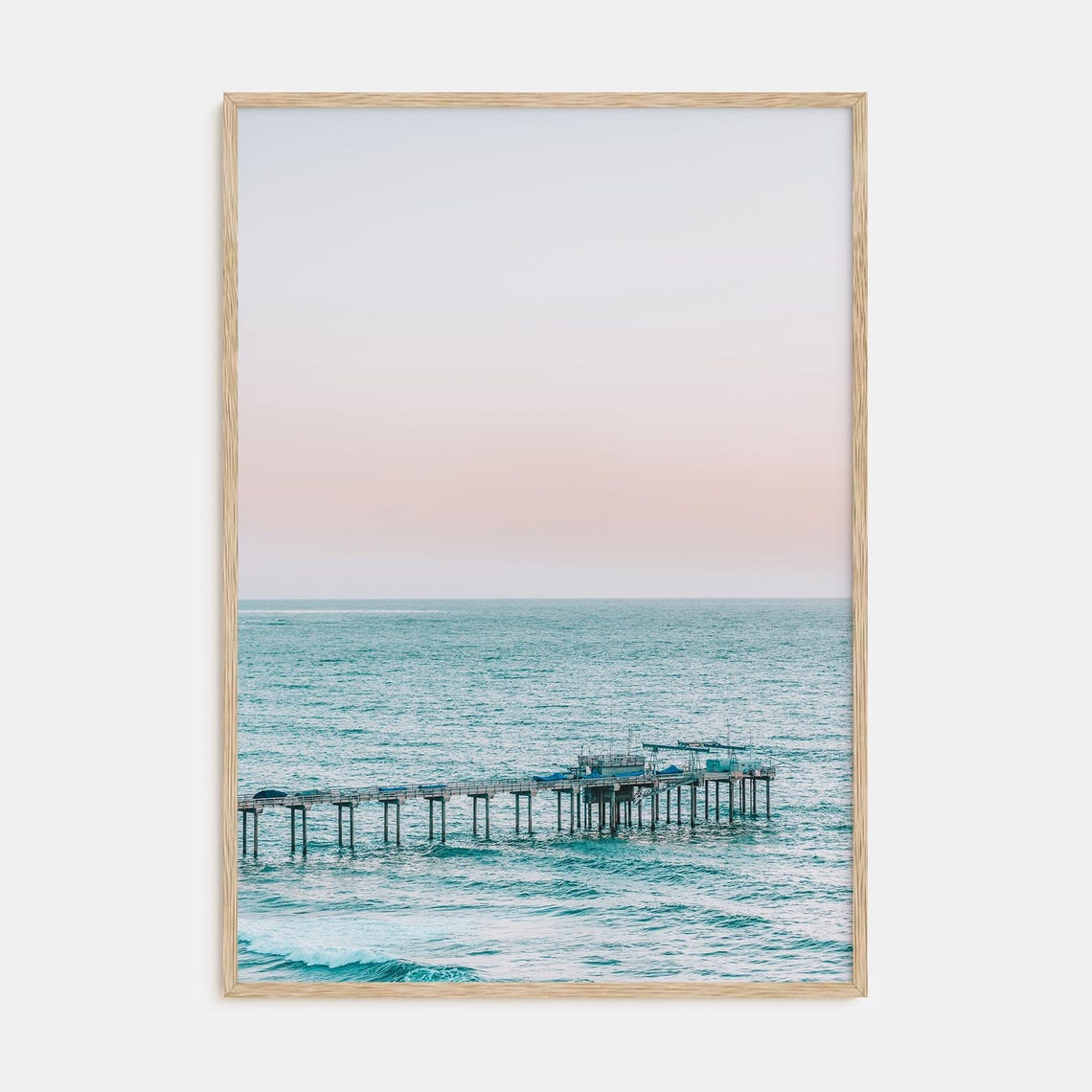 Long Pier Extending Into Turquoise Water Under Pink Sky Poster