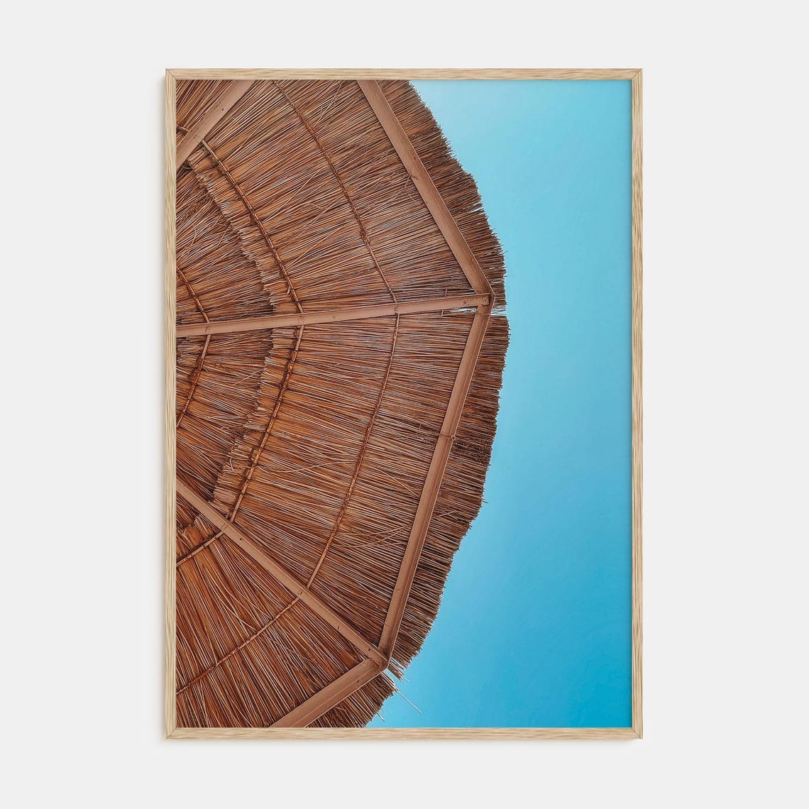 Woven Straw Beach Umbrella From Below Against a Bright Blue Sky Poster