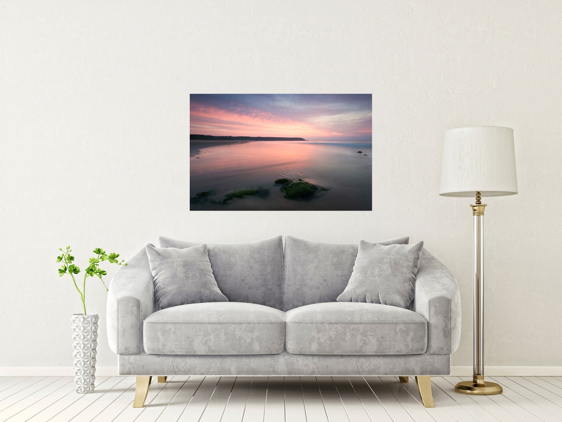 Soft Pink Sunset Over a Calm Shoreline with Mossy Rocks Poster - Image 2