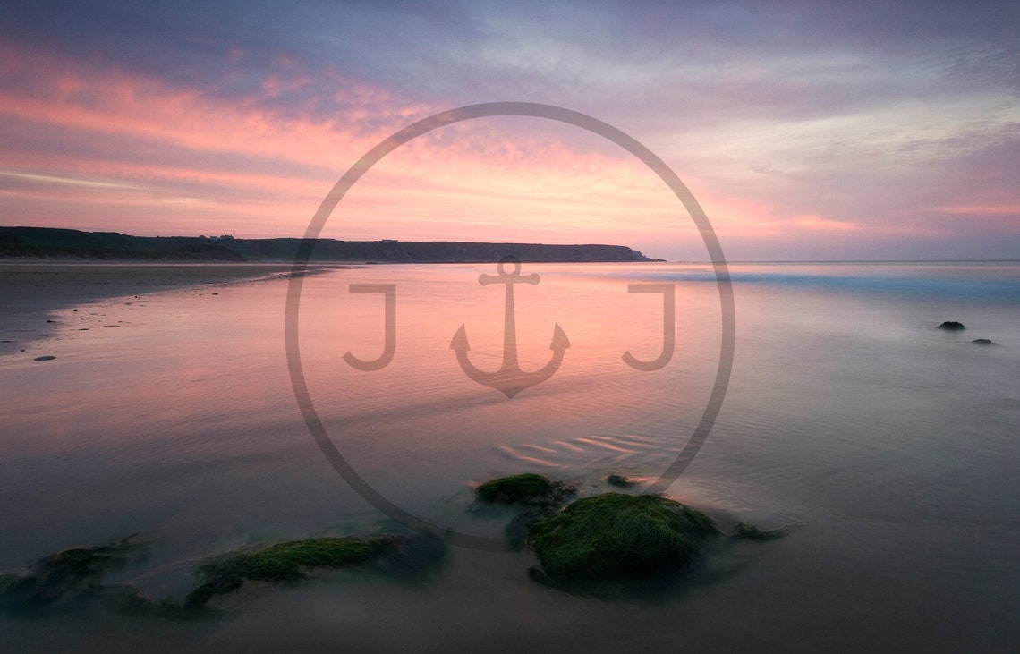 Soft Pink Sunset Over a Calm Shoreline with Mossy Rocks Poster - Image 3