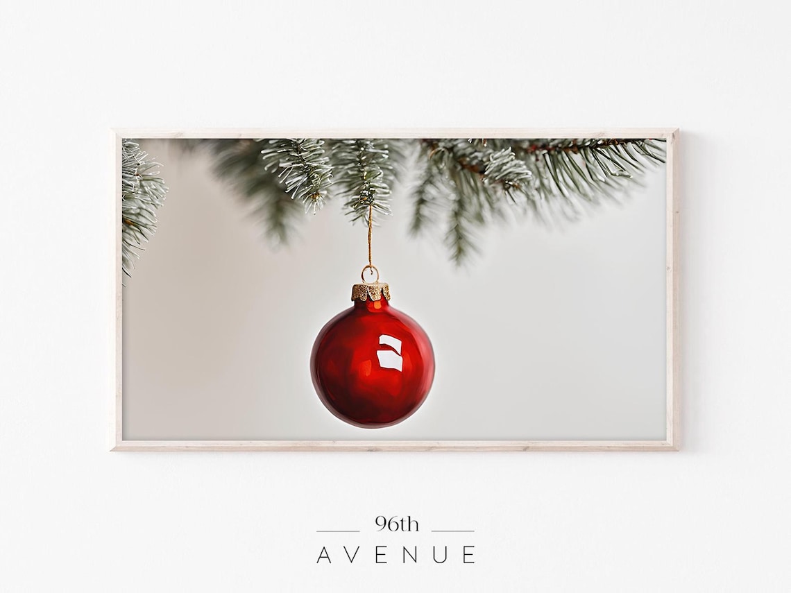 Red Christmas Bauble Hanging From Snowy Pine Branch Winter Poster