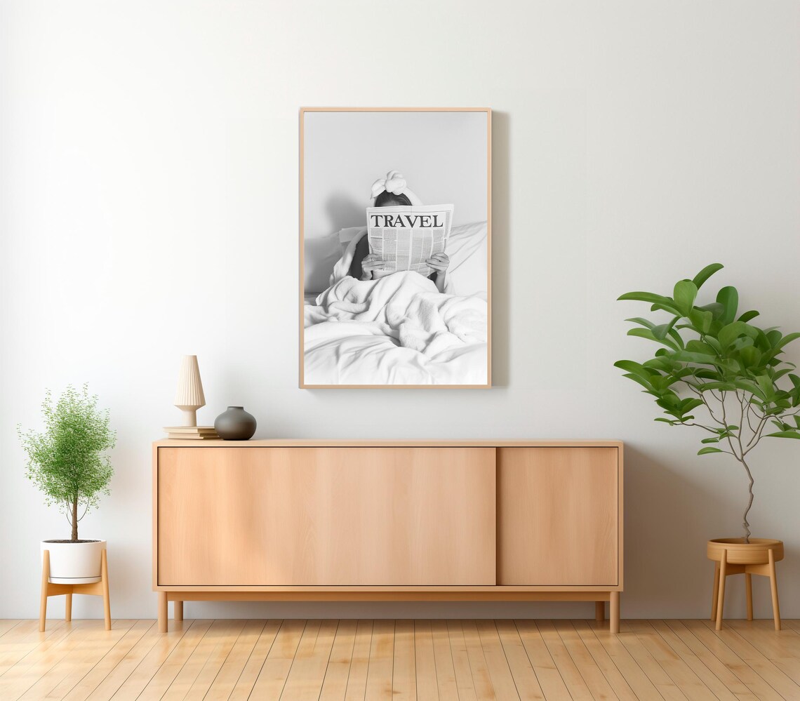 Woman Reading Travel Newspaper in Bed Black and White Poster - Image 2