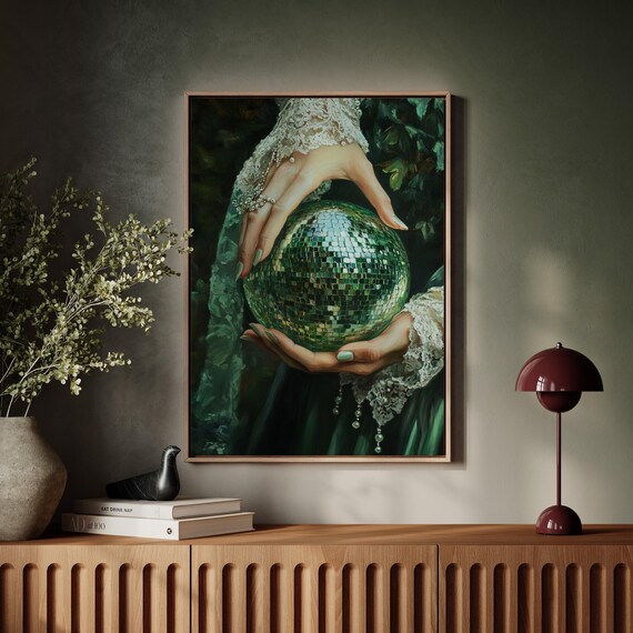 Woman in Green Dress Holding Sparkling Disco Ball in Hands Poster