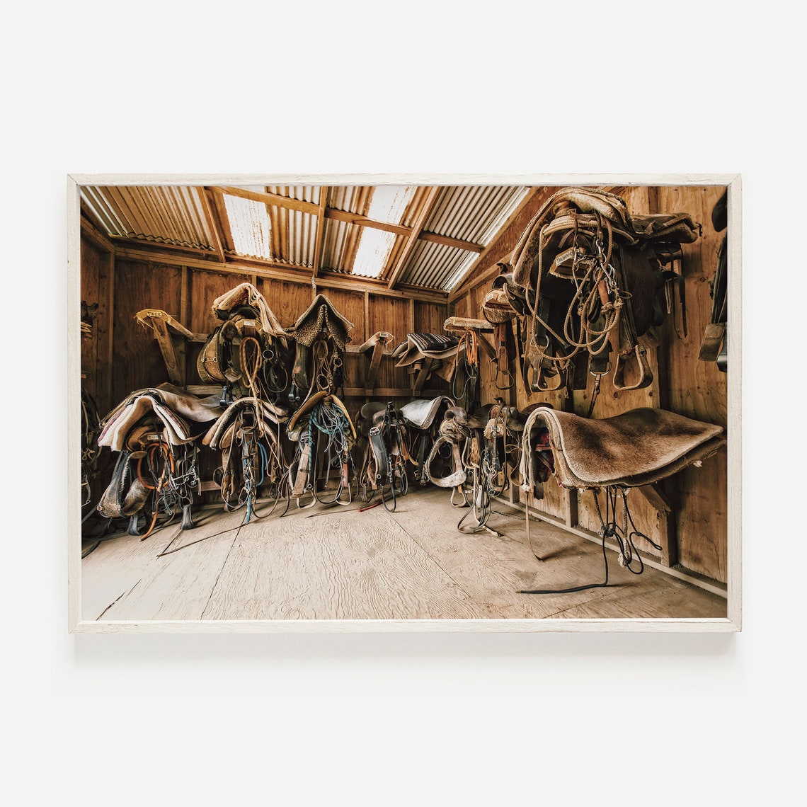 Worn Saddles and Tack Hanging Inside Rustic Wooden Barn Photo Print