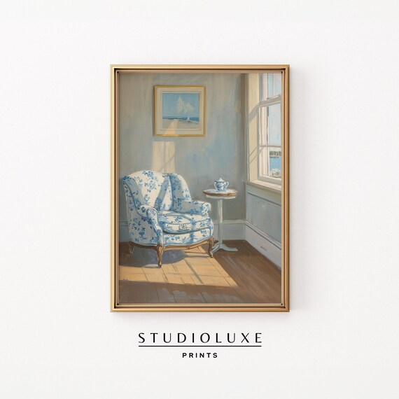 Sunlit Coastal Sitting Room with Blue Floral Armchair and Sea View Poster