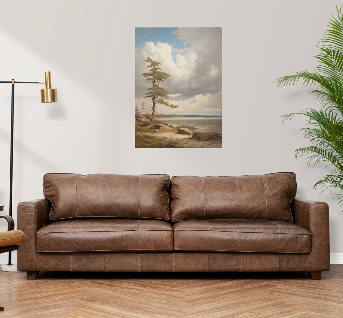 Lone Pine Tree on Rocky Shore Beneath Dramatic Cloudy Sky Poster - Image 3