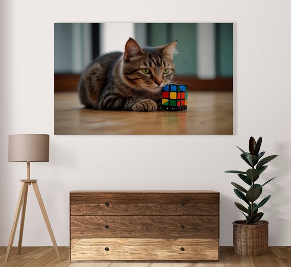 Charming Brown Tabby Cat Napping Next to Colorful Rubik Cube Poster